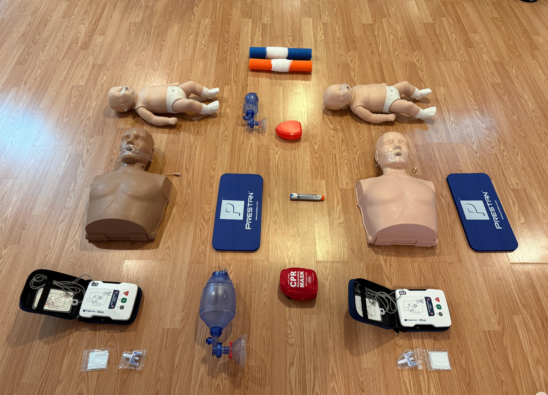 Students holding their new CPR certification cards after a class
